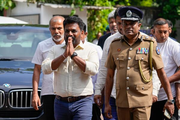 Sri Lankan President Anura Kumara Dissanayake greets as he arrives to cast his vote during the parliamentary election in Colombo, Sri Lanka, Thursday, Nov. 14, 2024.(AP Photo/Eranga Jayawardena)