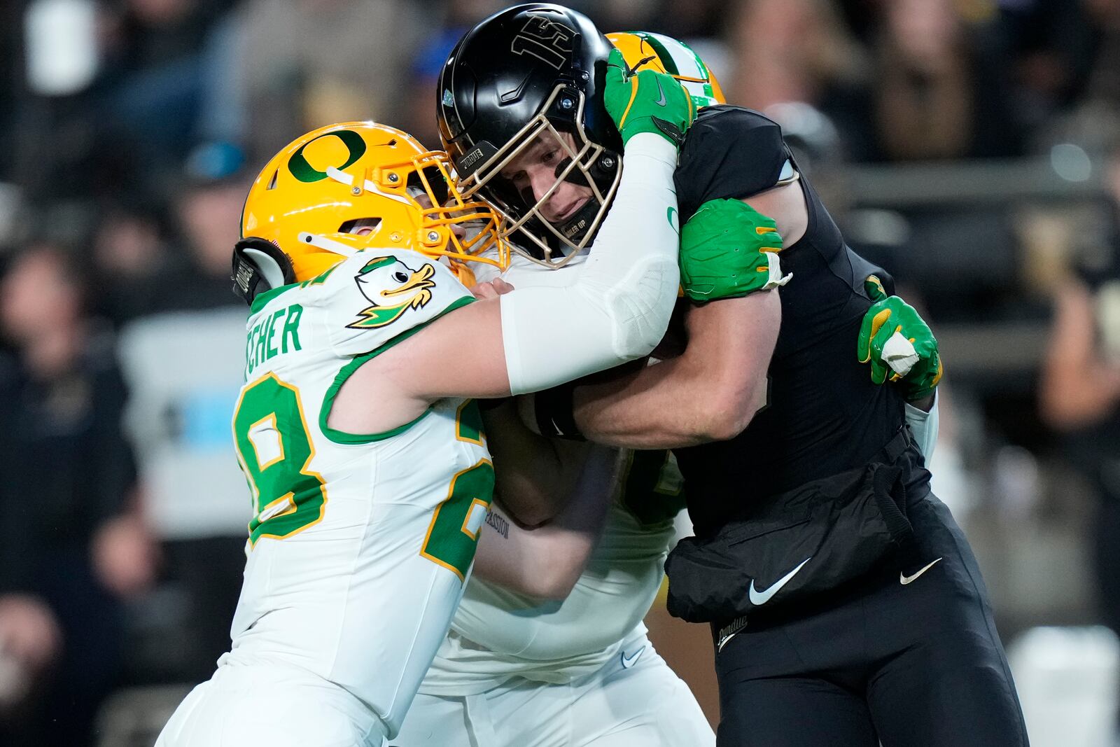 Purdue quarterback Ryan Browne, right, is tackled by Oregon linebacker Bryce Boettcher, left, during the first half of an NCAA college football game in West Lafayette, Ind., Friday, Oct. 18, 2024. (AP Photo/AJ Mast)