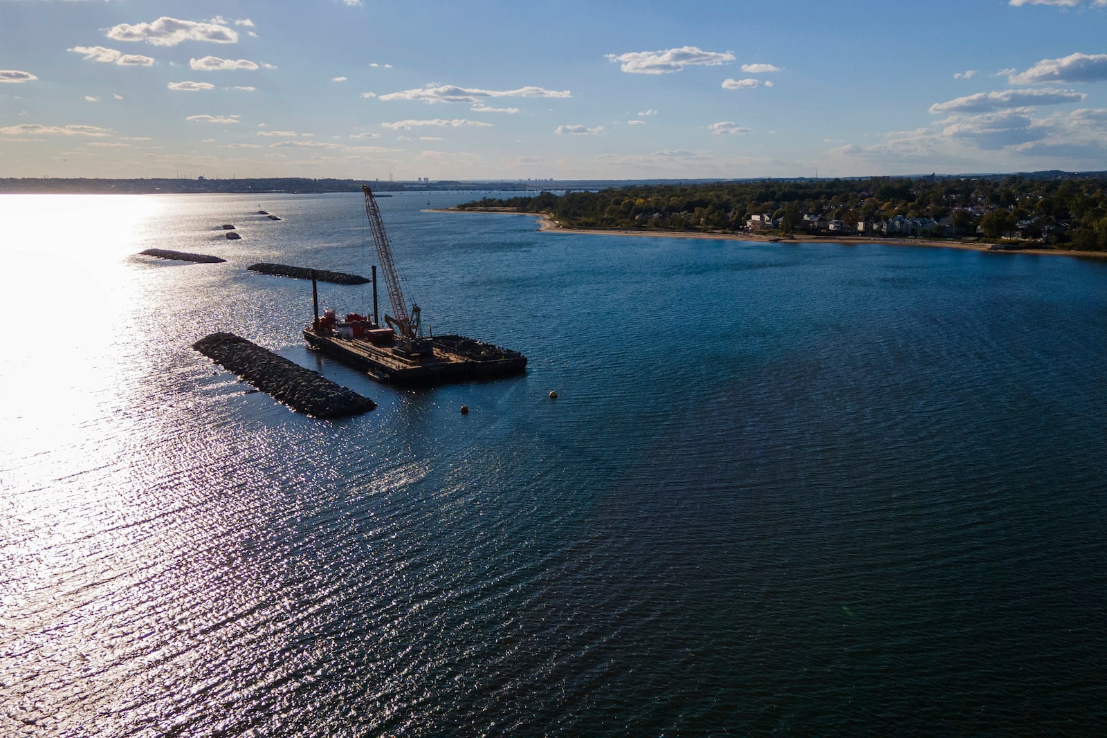 Construction is wrapping up on eight, eco-friendly "Living Breakwaters" at the southernmost tip of New York City, off the coast of Staten Island, Wednesday, Oct. 9, 2024, where artificial reefs were constructed as part of a strategy to reduce risk from hurricanes after Superstorm Sandy pummeled the region in 2012. (AP Photo/Ted Shaffrey)