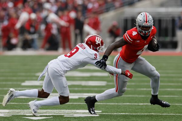 Indiana defensive back Jamier Johnson, left, tries to tackle Ohio State receiver Jeremiah Smith during the first half of an NCAA college football game Saturday, Nov. 23, 2024, in Columbus, Ohio. (AP Photo/Jay LaPrete)