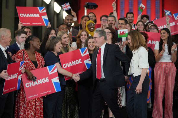 Labour Party leader Keir Starmer shakes hands with his supporters at the Tate Modern in London, Friday, July 5, 2024. Labour Party Starmer says voters "have spoken and they are ready for change" as an exit poll points to landslide win, and is expected to be the next British Prime Minister. (AP Photo/Kin Cheung)