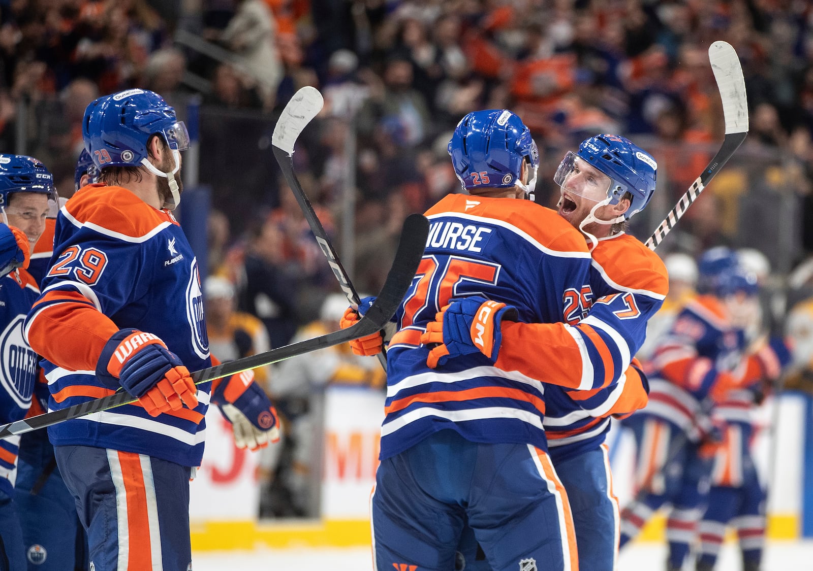 Edmonton Oilers' Darnell Nurse (25) and Connor McDavid (97) celebrate after their win over the Nashville Predators during overtime NHL hockey game action in Edmonton, Alberta, Thursday, Nov. 14, 2024. (Jason Franson/The Canadian Press via AP)