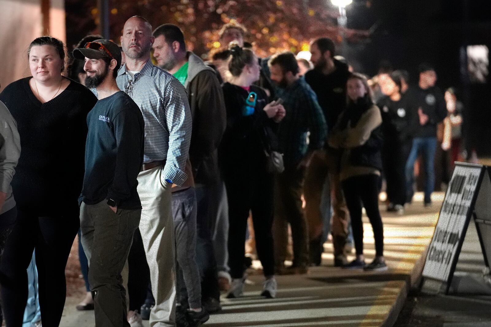 Voters stand in line to enter a polling place on the campus of Pinkerton Academy, Tuesday, Nov. 5, 2024, in Derry, N.H. (AP Photo/Steven Senne)