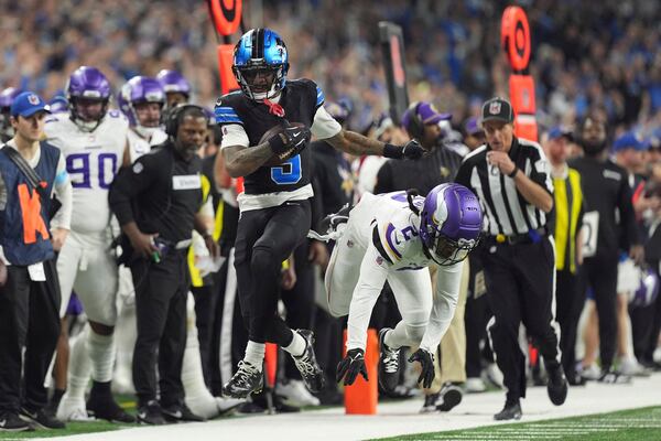 Detroit Lions wide receiver Jameson Williams (9) runs past Minnesota Vikings cornerback Stephon Gilmore (2) for a first down during the first half of an NFL football game Sunday, Jan. 5, 2025, in Detroit. (AP Photo/Charlie Riedel)