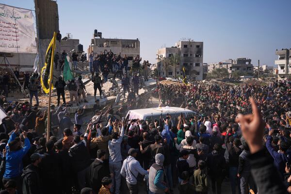 People surround the cars carrying Israeli Gadi Mozes and Arbel Yahoud, who have been held hostages by Hamas in Gaza since October 7, 2023, as they are escorted by Hamas and Islamic Jihad fighters as they are handed over to the Red Cross in Khan Younis, southern Gaza Strip, Thursday Jan. 30, 2025.(AP Photo/Abdel Kareem Hana)