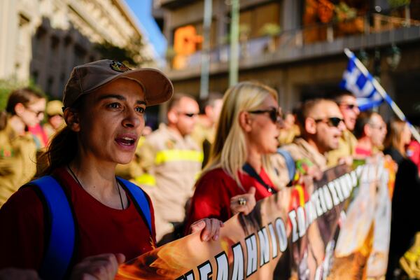 Seasonal firefighters take part in rally, during a nationwide general strike organized by private and public sector unions demanding for better wages, in Athens, Greece, Wednesday, Nov. 20, 2024. (AP Photo/Thanassis Stavrakis)