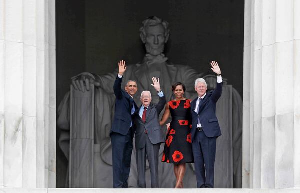 FILE - From left, President Barack Obama, former President Jimmy Carter, first lady Michelle Obama and former President Bill Clinton wave from the Lincoln Memorial in Washington during a celebration of the 50th anniversary of the March on Washington where Martin Luther King Jr. spoke, Aug. 28, 2013. (AP Photo/Charles Dharapak, File)