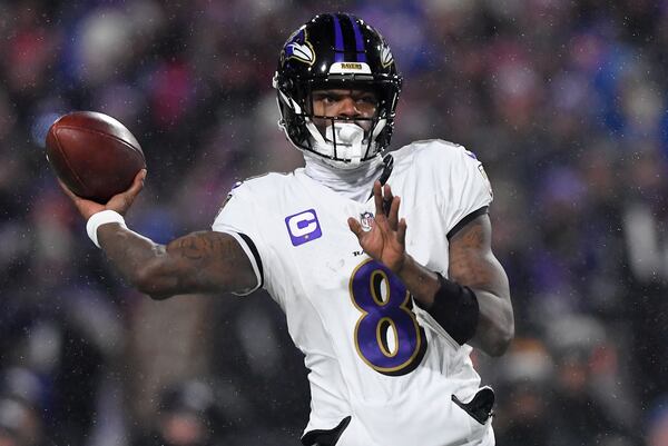 Baltimore Ravens quarterback Lamar Jackson (8) passes against the Buffalo Bills during the first quarter of an NFL divisional playoff football game, Sunday, Jan. 19, 2025, in Orchard Park, N.Y. (AP Photo/Adrian Kraus)