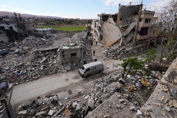 Residents inspect a destroyed neighbourhood in Baalbek, eastern Lebanon, Thursday, Nov. 28, 2024. (AP Photo/Hassan Ammar)