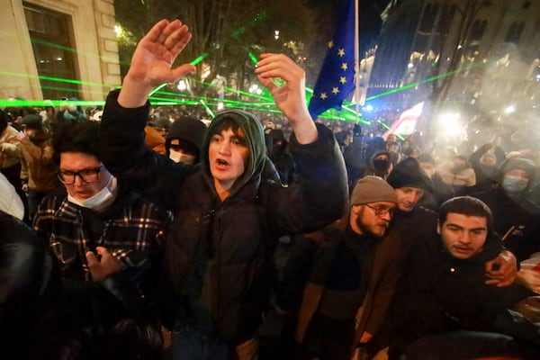 Protesters shout in front of police line as they pour into the streets following Georgian Prime Minister Irakli Kobakhidze's announcement, rallying outside the parliament building in Tbilisi, Georgia, on Friday, Nov. 29, 2024. (AP Photo/Zurab Tsertsvadze)