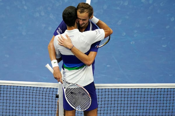 FILE - Daniil Medvedev, of Russia, right, hugs Novak Djokovic, of Serbia, after defeating Djokovic during the men's singles final of the US Open tennis championships, Sept. 12, 2021, in New York. (AP Photo/Seth Wenig, File)