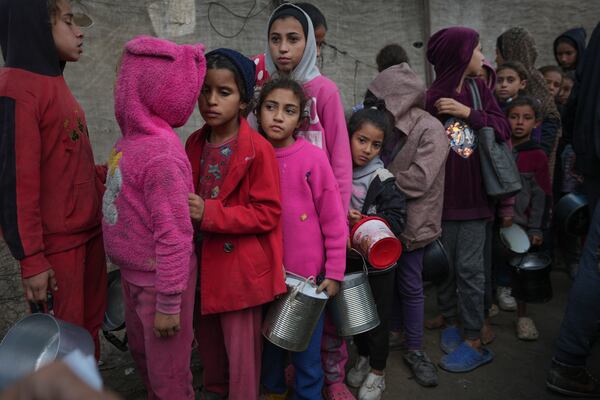 FILE - Palestinian children queue at a food distribution kitchen in Deir al-Balah, Gaza Strip, Thursday Nov. 28, 2024. (AP Photo/Abdel Kareem Hana, File)