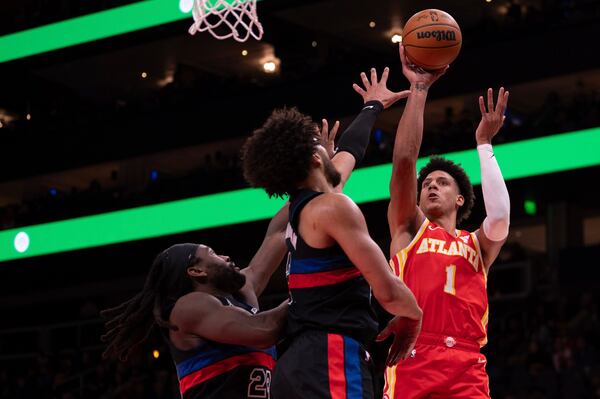 Atlanta Hawks forward Jalen Johnson (1) shoots the ball over Detroit Pistons guard Cade Cunningham (2) and Detroit Pistons center Isaiah Stewart (28) during the first half of an NBA basketball game on Wednesday, Jan. 22, 2025, in Atlanta. (AP Photo/Kathryn Skeean)