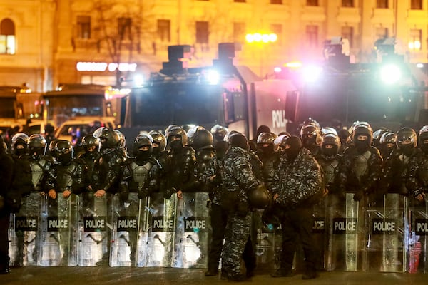 Police block a street to prevent demonstrators outside the parliament's building to continue protests against the government's decision to suspend negotiations on joining the European Union in Tbilisi, Georgia, on Monday, Dec. 2, 2024. (AP Photo/Zurab Tsertsvadze)