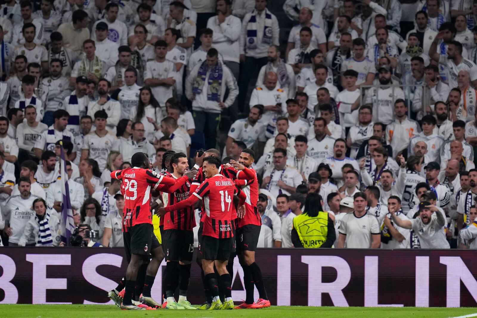 AC Milan's Tijjani Reijnders (14) celebrates with teammates after scoring his side's 3rd goal against Real Madrid during the Champions League opening phase soccer match at the Santiago Bernabeu stadium in Madrid, Spain, Tuesday, Nov. 5, 2024. (AP Photo/Manu Fernandez)