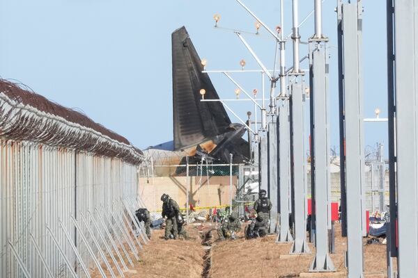 South Korean army soldiers work outside of Muan International Airport in Muan, South Korea, Tuesday, Dec. 31, 2024, following Sunday's plane crash. (AP Photo/Ahn Young-joon)