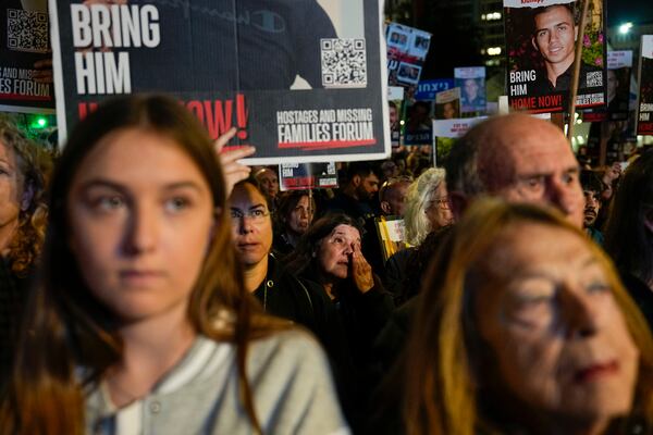 FILE.- Families and supporters of Israeli hostages held by Hamas in Gaza hold their photos and shout slogans during a rally calling for their release, in Tel Aviv, Israel, Saturday, Dec. 30, 2023. (AP Photo/Ariel Schalit, File)