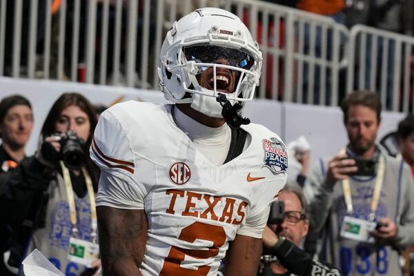 Texas wide receiver Matthew Golden (2) celebrates his two-point conversion against against Arizona State during overtime in the quarterfinals of a College Football Playoff game, Wednesday, Jan. 1, 2025, in Atlanta. Texas won 39-31 in two overtime periods. (AP Photo/Brynn Anderson)