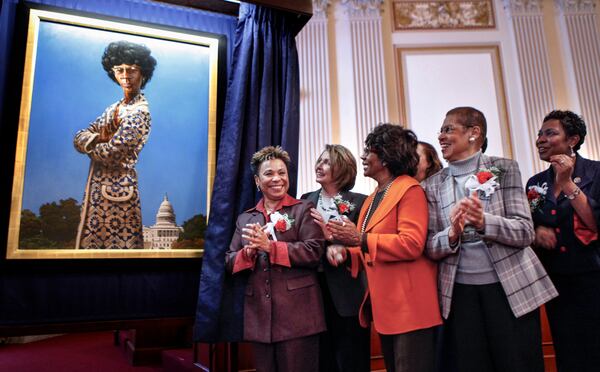 FILE—From left, Congressional Black Caucus Chair Rep. Barbara Lee, D- Calif., House Speaker Nancy Pelosi of Calif., Rep. Maxine Waters, D-Calif., Del. Eleanor Holmes Norton, D-D.C., and Rep. Yvette Clarke, D-N.Y.,applaud during the unveiling of the portrait of the late New York Rep. Shirley Chisholm, marking the 40th anniversary of Congresswoman Chisholm's swearing in as a Member of the House of representatives, Tuesday, March 3, 2009, on Capitol Hill in Washington. In 1968, Chisholm became the first African-American woman elected to Congress. (AP Photo/Manuel Balce Ceneta, File)