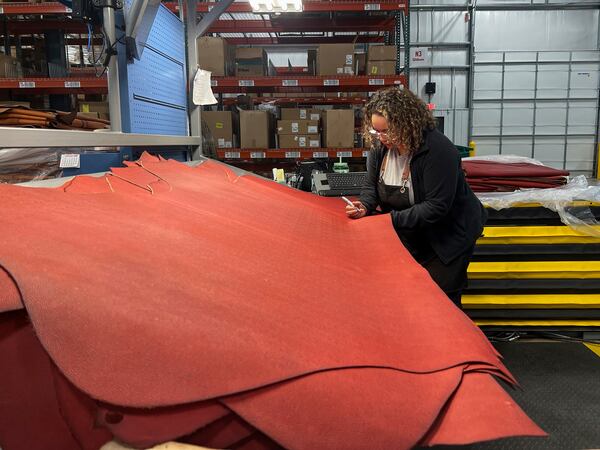 Sarena Hardia, inspects the material before it is cut into the shape of a football for the upcoming Super Bowl matchup between the Philadelphia Eagles and the Kansas City Chiefs inside the Wilson Sporting Goods football factory, Monday, January 27, 2025, in Ada, Ohio. (AP Photo/Patrick Aftoora-Orsagos)