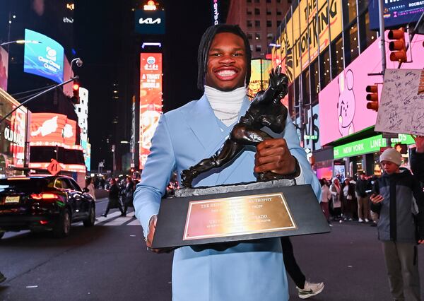 Travis Hunter poses with the Heisman Trophy after winning it as the outstanding player in college football Saturday, Dec. 14, 2024, in New York. (Todd Van Emst/Heisman Trust via AP, Pool)