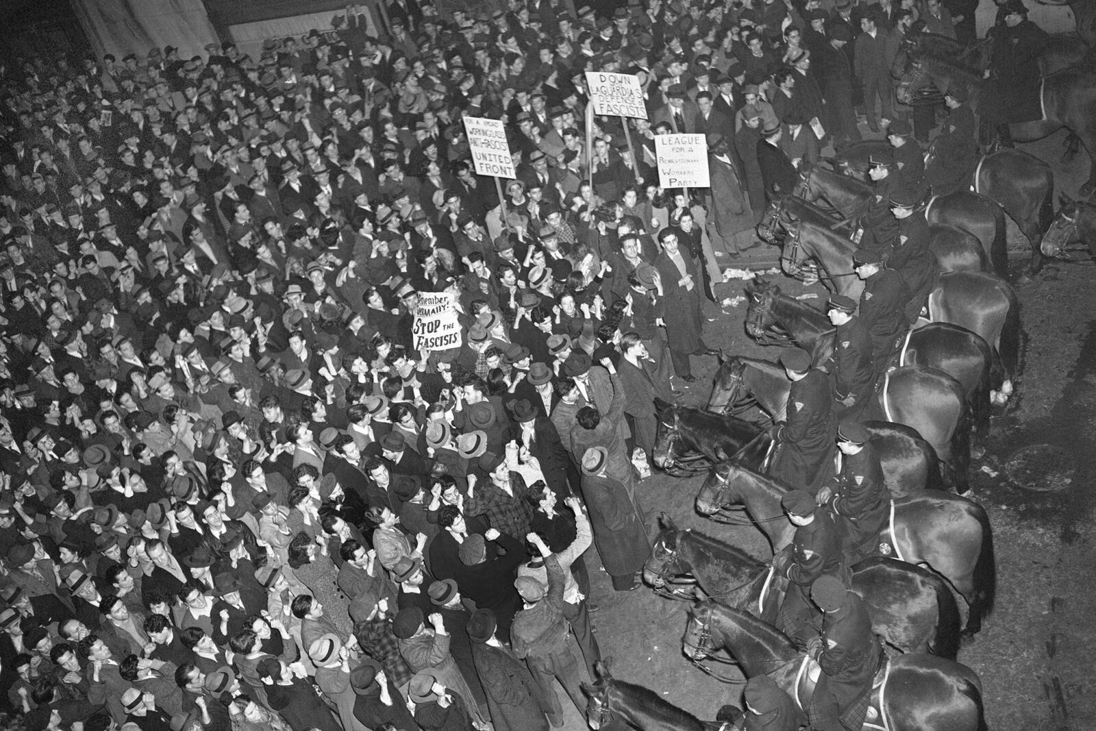 FILE - In this Feb. 20, 1939 file photo, New York City's mounted police form a line outside Madison Square Garden to hold in check a crowd that packed the streets where the German American Bund was holding a rally. (AP Photo/Murray Becker, File)