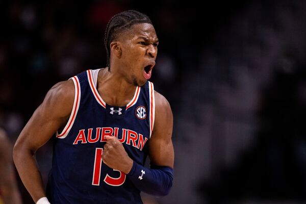 Auburn guard Miles Kelly (13) celebrates during the second half of an NCAA college basketball game against the South Carolina, Saturday, Jan. 11, 2025, in Columbia, S.C. (AP Photo/Scott Kinser)