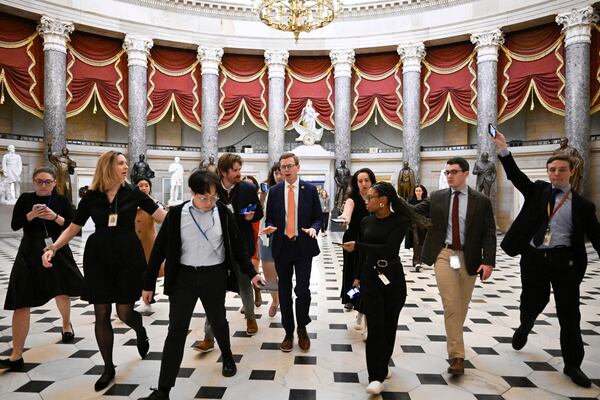 Rep. Dusty Johnson, R-S.D., talks with reporters after attending a meeting with Speaker of the House Mike Johnson, R-La., as the House works on a spending bill to avert a shutdown of the Federal Government, Friday, Dec. 20, 2024, at the Capitol in Washington. (AP Photo/John McDonnell)