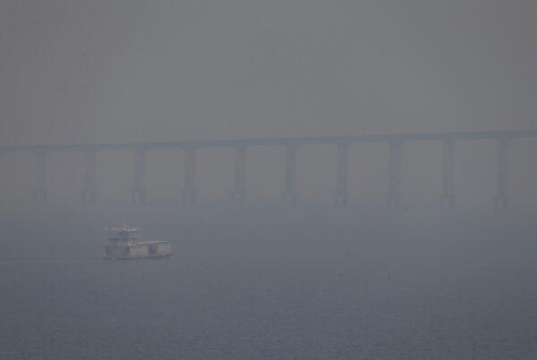 FILE - A boat navigates the Negro River amid smoke from wildfires in Manaus, Amazonas state, Brazil, Aug. 27, 2024. (AP Photo/Edmar Barros, File)