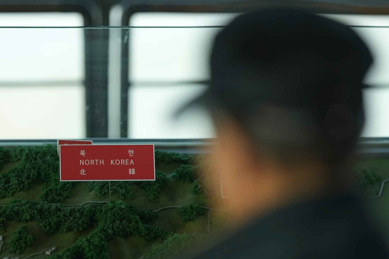 A visitor looks at a map of two Koreas border area at the unification observatory in Paju, South Korea, Thursday, Oct. 31, 2024. (AP Photo/Lee Jin-man)