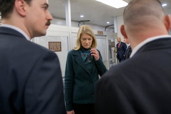 Sen. Lisa Murkowski, R-Alaska, talks with reporters as she makes her way through the Senate subway, Thursday, Jan. 23, 2025, in Washington. (AP Photo/Rod Lamkey, Jr.)