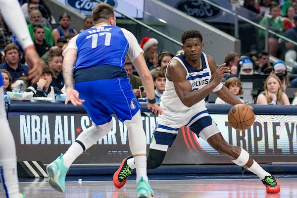 Minnesota Timberwolves guard Anthony Edwards (5) makes a move on Dallas Mavericks guard Luka Doncic (77) in the first half of an NBA basketball game on Wednesday, Dec. 25, 2024, in Dallas.(AP Photo/Emil T. Lippe)