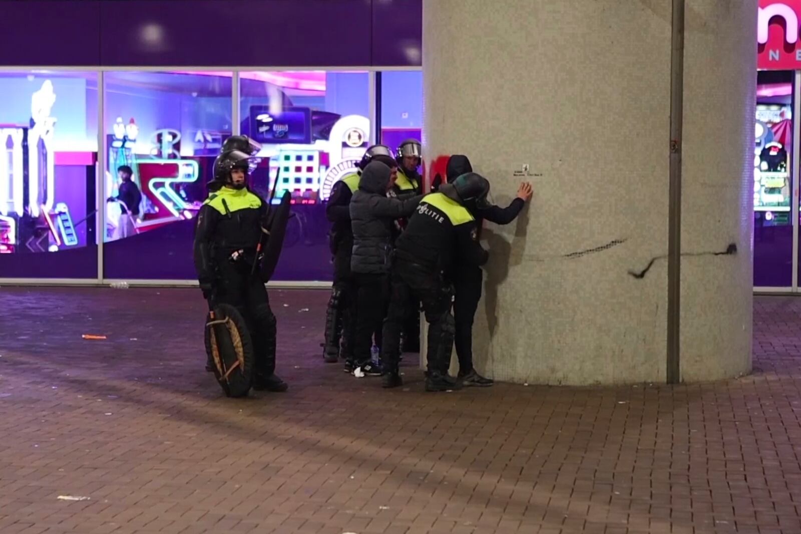 In this image taken from video, police frisk pro-Palestinian supporters near the Ajax stadium in Amsterdam, the Netherlands, Thursday, Nov. 7, 2024. (AP Photo InterVision)