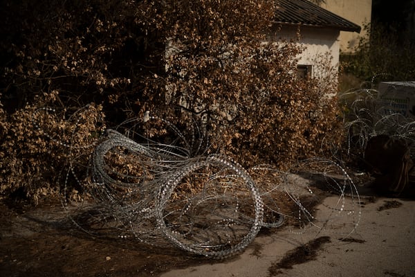 Barbed wires are set on an area in front a house of the Kibbutz Manara, which is located near to the border with Lebanon in the northern Israel, Thursday, Nov. 28, 2024. (AP Photo/Leo Correa)