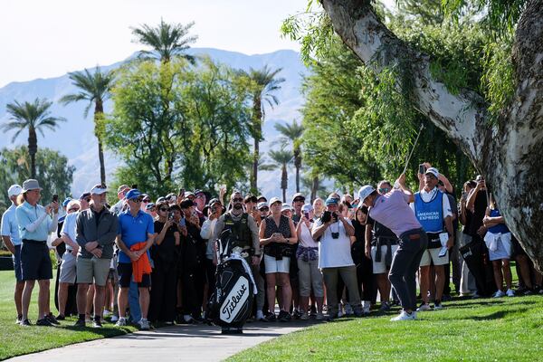 Fans watch as Justin Thomas hits to the fourth fairway at La Quinta Country Club Course during the first round of the American Express golf tournament in La Quinta, Calif., Thursday, Jan. 16, 2025. (AP Photo/William Liang)