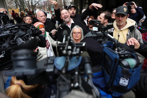 Pat King, top center, a prominent figure in Canada’s trucker protests against COVID-19 restrictions in 2022, is surrounded by supporters and media as he leaves court in Ottawa, Ontario, Friday, Nov. 22, 2024. (Sean Kilpatrick/The Canadian Press via AP)