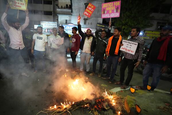 Activists of Bajarang dal, a Hindu rights group, burn an effigy of Bangladesh's interim leader Muhammad Yunus, during a protest against the alleged attacks on Hindus in Bangladesh, in Ahmedabad, India, Wednesday, Dec. 11, 2024. (AP Photo/Ajit Solanki)