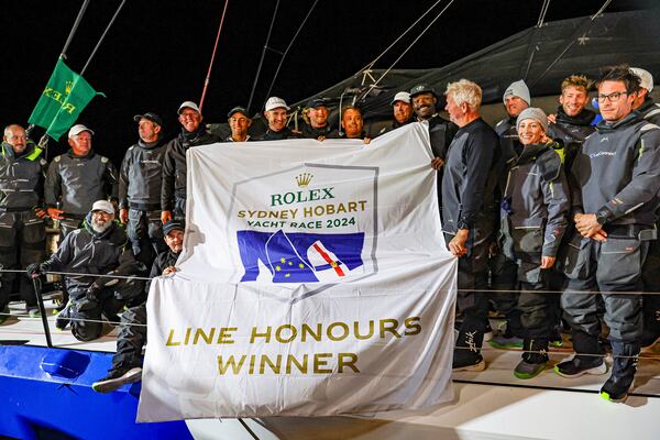 Crew of Law Connect pose for a photo after winning line honours in the Sydney to Hobart yacht race in Hobart, Australia, Saturday, Dec. 28, 2024. (Salty Dingo via AP)