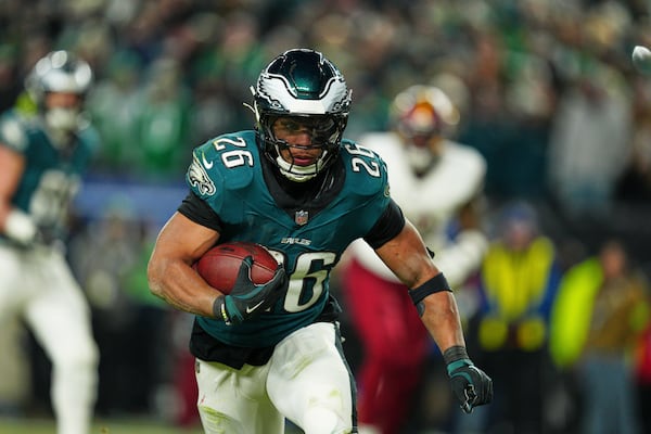 Philadelphia Eagles running back Saquon Barkley (26) rushes for a touchdown against the Washington Commanders during the second half of the NFC Championship NFL football game, Sunday, Jan. 26, 2025, in Philadelphia. (AP Photo/Derik Hamilton)