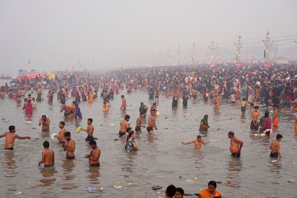 Hindu devotees take a holy dip in the Sangam, the confluence of the Ganges, the Yamuna and the mythical Saraswati rivers, on "Mauni Amavasya" or new moon day during the Maha Kumbh festival in Prayagraj, India, Wednesday, Jan. 29, 2025. (AP Photo/Deepak Sharma)