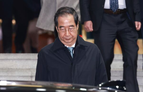 Impeached South Korean acting President Han Duck-soo leaves the government complex building in Seoul, South Korea, Friday, Dec. 27, 2024. (Hong Hae-in/Yonhap via AP)