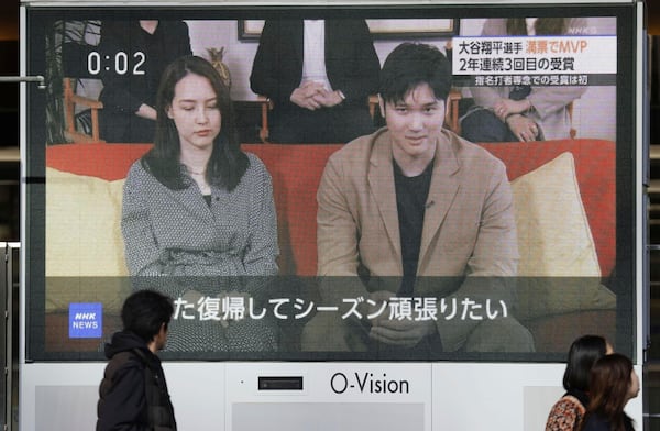 A huge screen in Osaka, western Japan shows a news report on Los Angeles Dodgers' Shohei Ohtani winning his third Most Valuable Player award, Friday, Nov. 22, 2024. (Kyodo News via AP)