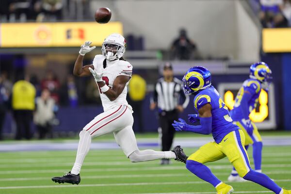 Arizona Cardinals wide receiver Marvin Harrison Jr., left, makes a catch past Los Angeles Rams safety Quentin Lake, right, during the second half of an NFL football game Saturday, Dec. 28, 2024, in Inglewood, Calif. (AP Photo/Ryan Sun)