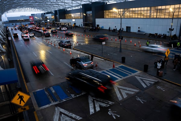 Travelers arrive at Hartsfield-Jackson Atlanta International Airport, Tuesday, Nov. 26, 2024, in Atlanta. (AP Photo/Olivia Bowdoin)