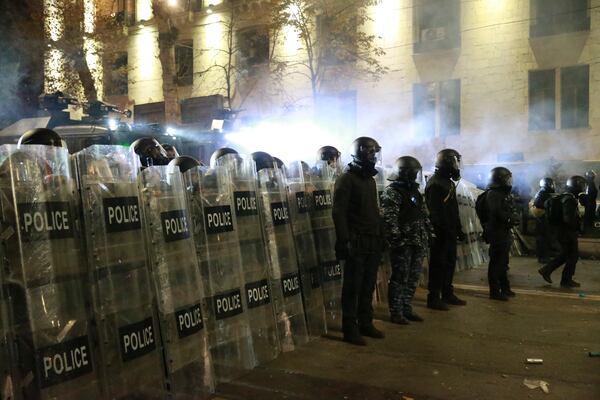 Police block a street to stop protesters rallying against the government's decision to suspend negotiations on joining the European Union in Tbilisi, Georgia, early Tuesday, Dec. 3, 2024. (AP Photo/Zurab Tsertsvadze)