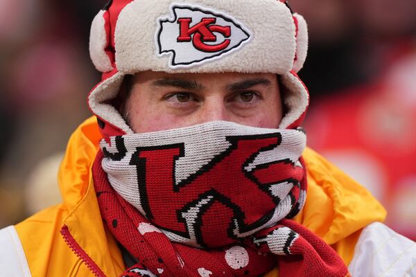 A person is bundled up for the cold during the first half of an NFL football AFC divisional playoff game between the Kansas City Chiefs and the Houston Texans Saturday, Jan. 18, 2025, in Kansas City, Mo. (AP Photo/Charlie Riedel)