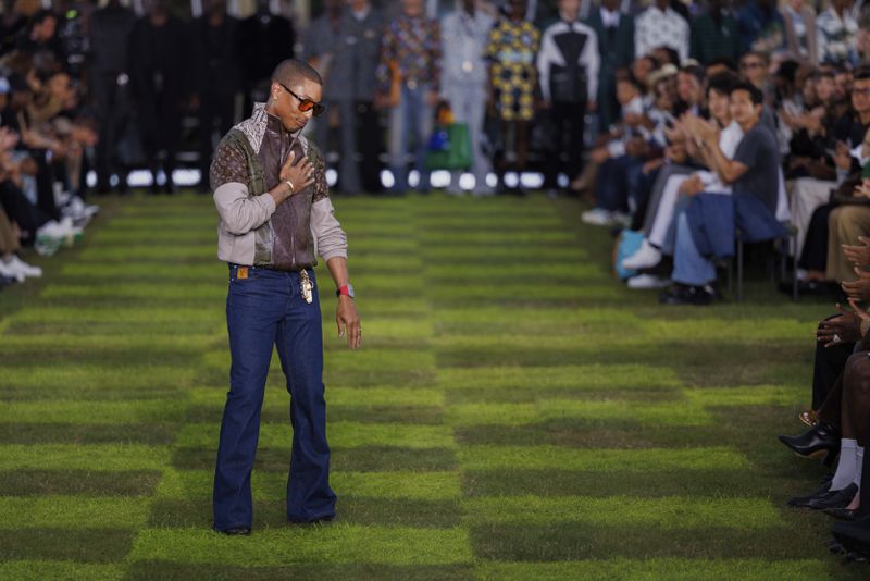 Creative director Pharrell Williams accepts applause following the Louis Vuitton Spring Summer 2025 collection, that was presented in Paris, Tuesday, June 18, 2024. (Photo by Vianney Le Caer/Invision/AP)